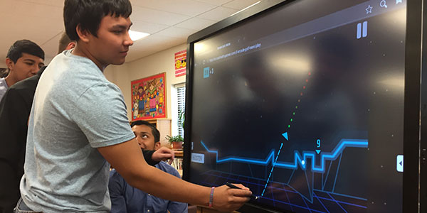 Students drawing lines on an interactive display from Data Projections