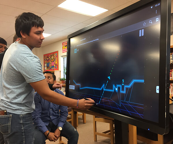Students drawing lines on an interactive display from Data Projections