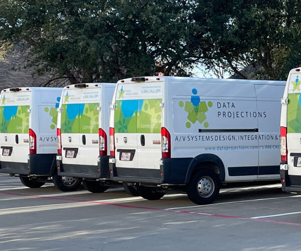 Data Projections vans in a parking lot